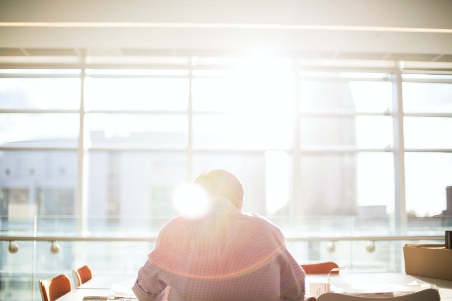 Sunshine Beaming on Man at Desk